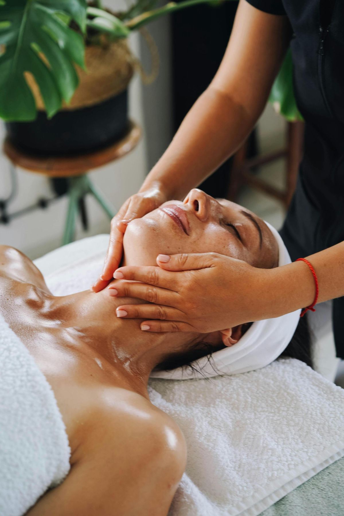A woman relaxes during a spa facial treatment